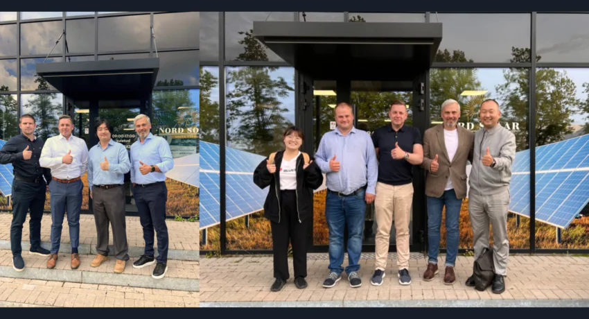 Nord Solari juhatus koostööpartneritega. Päikesepaneelid taustal pildil.